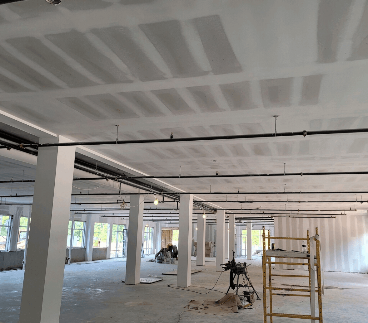 Commercial interior with drywall ceiling and steel columns